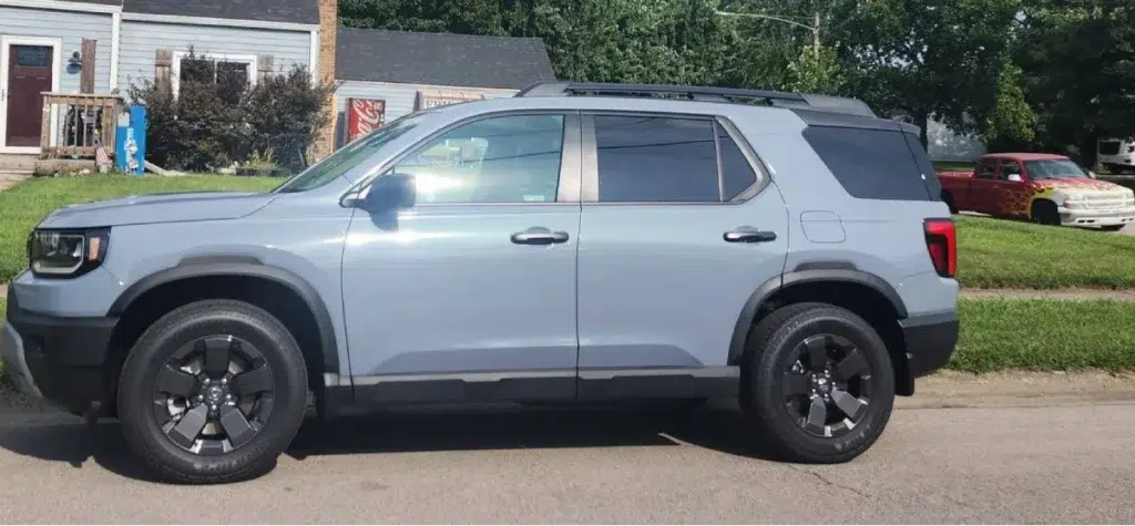 Side profile of a washed and polished grey Honda SUV following car detailing.
